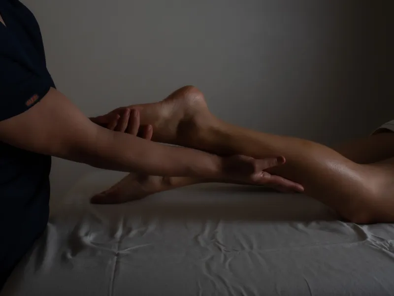 Professional masseur performing a relaxing foot massage on a client