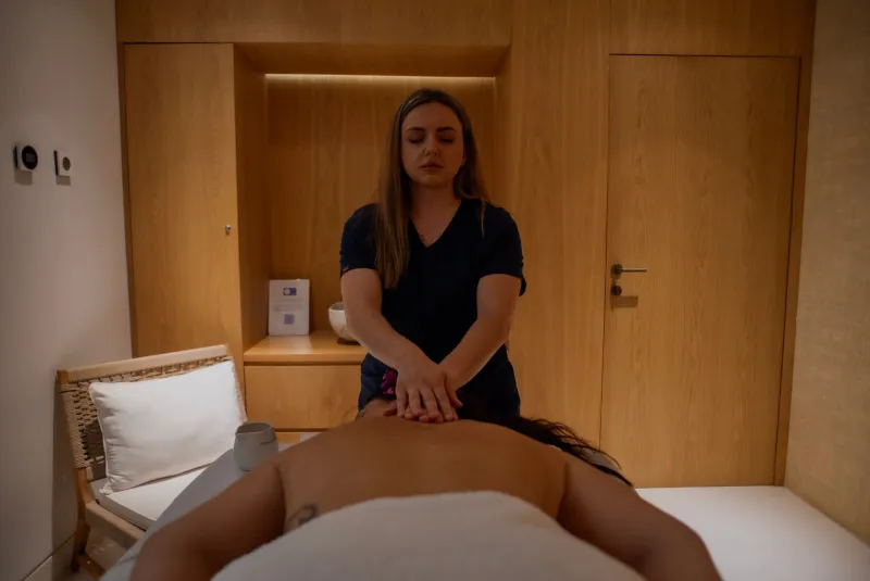 Professional therapist performing back massage in a calm spa setting